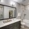 Bathroom with dual sinks and large mirror