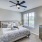 Apartment bedroom with natural lighting and ceiling fan